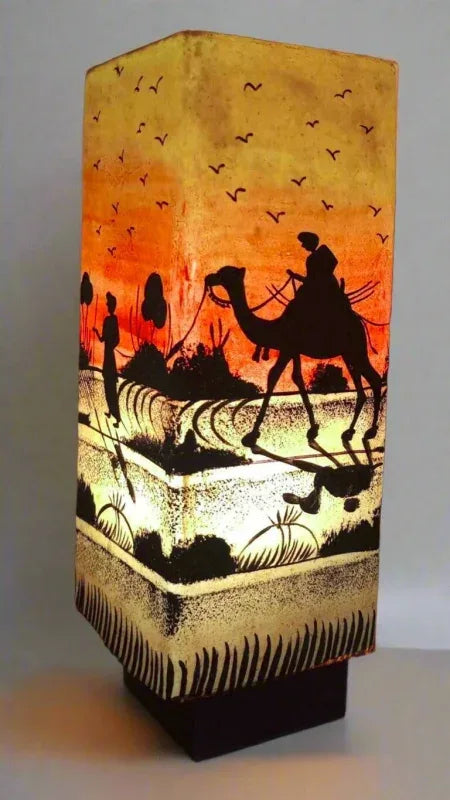 Box shape camel skin lamp near tree art